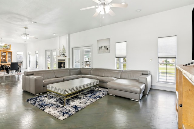 living room featuring ceiling fan and french doors