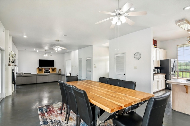 dining room featuring ceiling fan and finished concrete flooring