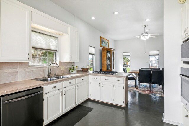 kitchen featuring white cabinets, backsplash, sink, and stainless steel appliances