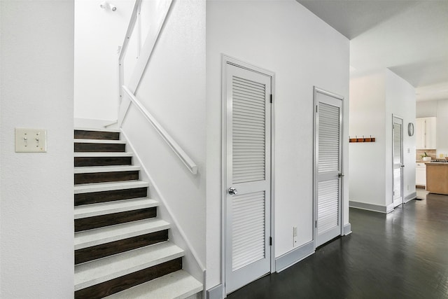 stairs featuring baseboards and wood finished floors