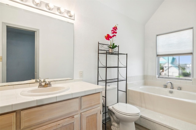 full bathroom with vaulted ceiling, vanity, toilet, and a tub