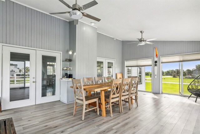 dining room featuring ceiling fan, french doors, and light wood-type flooring