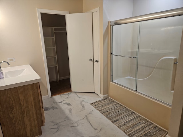 bathroom with enclosed tub / shower combo, vanity, and hardwood / wood-style floors