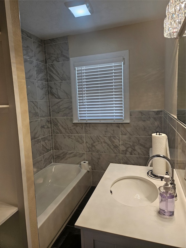 bathroom featuring vanity and tile walls