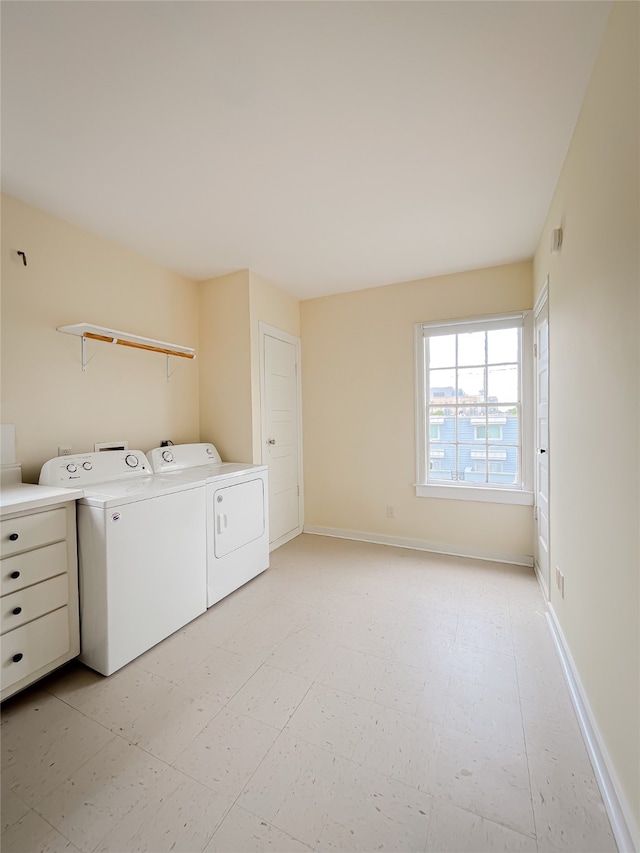 laundry area featuring independent washer and dryer, light tile floors, and washer hookup