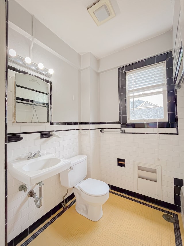 bathroom featuring tile flooring, backsplash, toilet, and tile walls