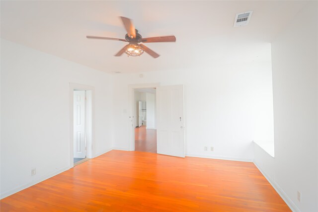 empty room featuring ceiling fan and hardwood / wood-style flooring