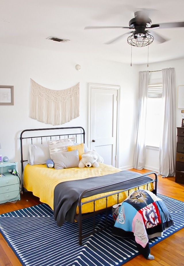 bedroom with ceiling fan and hardwood / wood-style floors