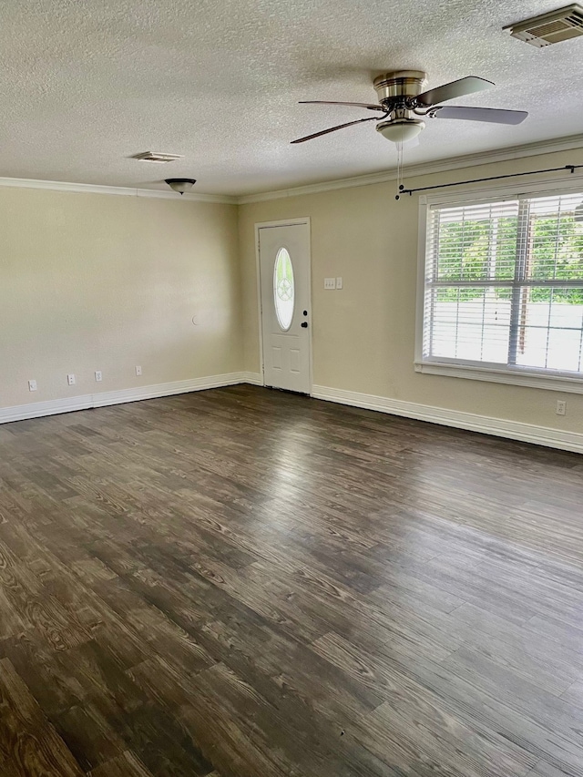 empty room featuring dark hardwood / wood-style floors, ceiling fan, a textured ceiling, and crown molding