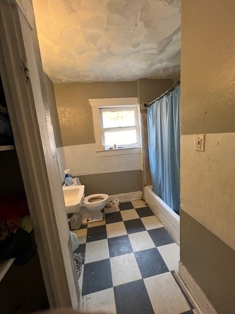 bathroom with tile floors, sink, and toilet