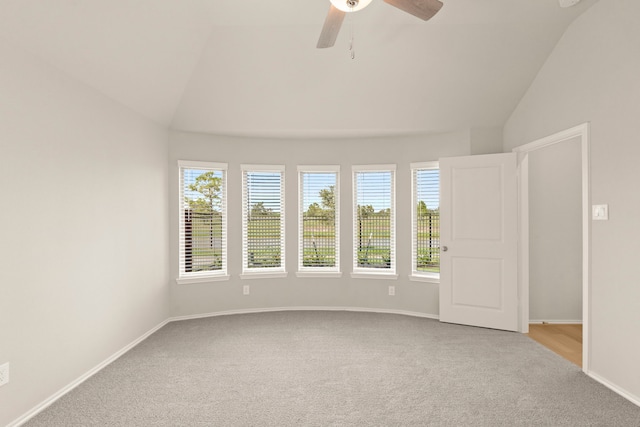 interior space featuring lofted ceiling, ceiling fan, and light carpet