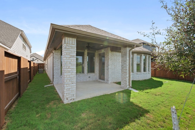 back of property featuring a lawn, a patio, and ceiling fan