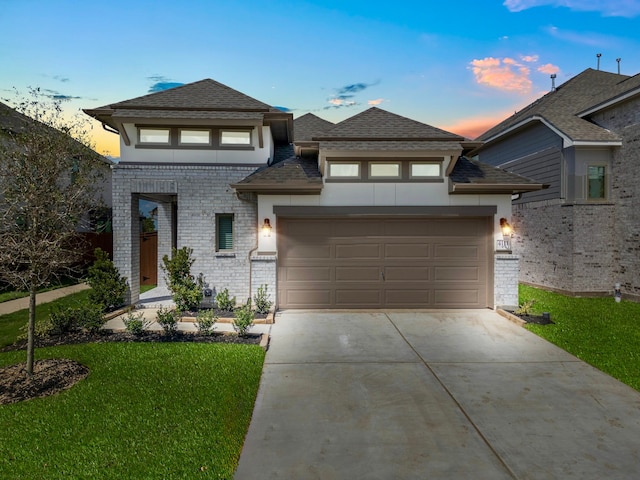 view of front of property with a lawn and a garage