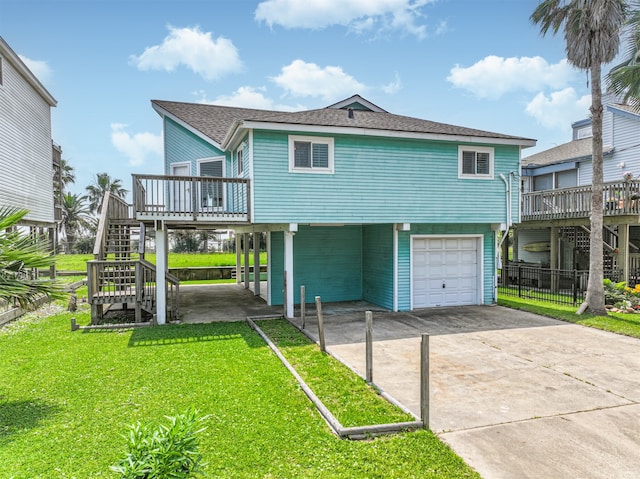 exterior space featuring a garage, a carport, a wooden deck, and a lawn