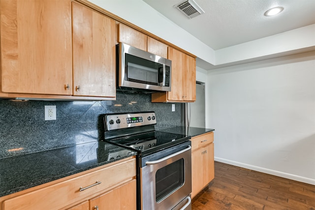 kitchen with decorative backsplash, dark hardwood / wood-style flooring, a textured ceiling, and appliances with stainless steel finishes