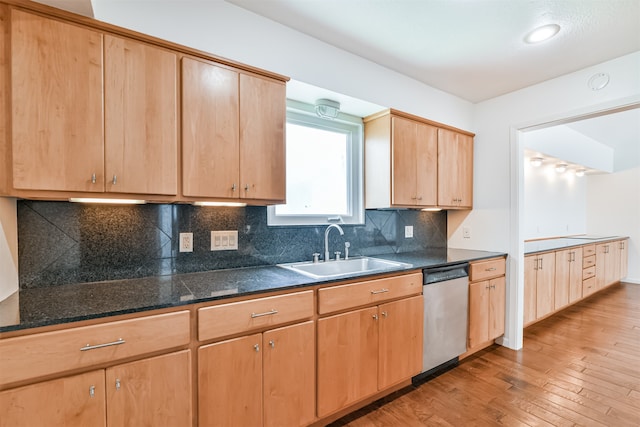 kitchen with dishwasher, light brown cabinets, sink, light hardwood / wood-style flooring, and decorative backsplash