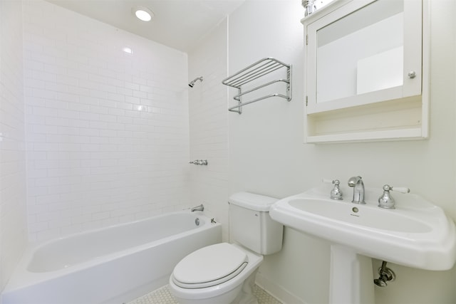 bathroom with tile patterned floors, tiled shower / bath combo, and toilet