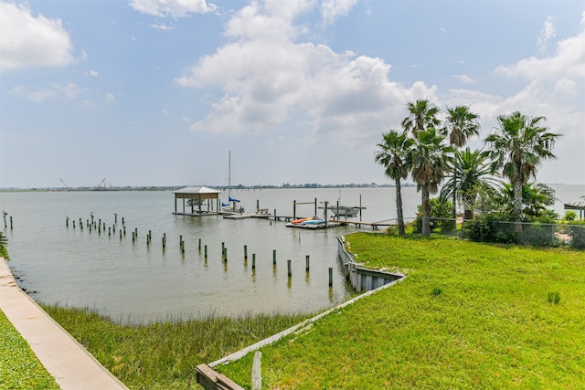 dock area featuring a lawn and a water view