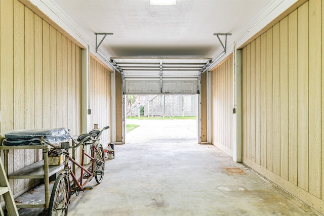 garage featuring wood walls