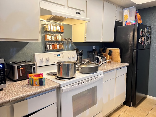 kitchen with light tile floors, white cabinetry, white range with electric stovetop, and black fridge