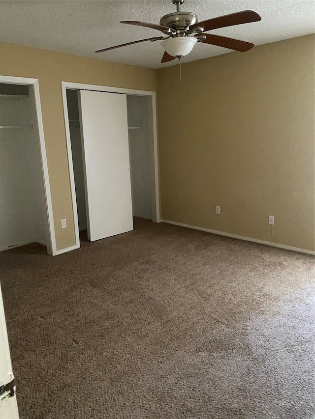 unfurnished bedroom featuring a textured ceiling, carpet, and ceiling fan