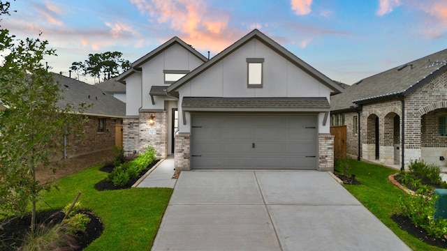 view of front of home featuring a garage and a yard