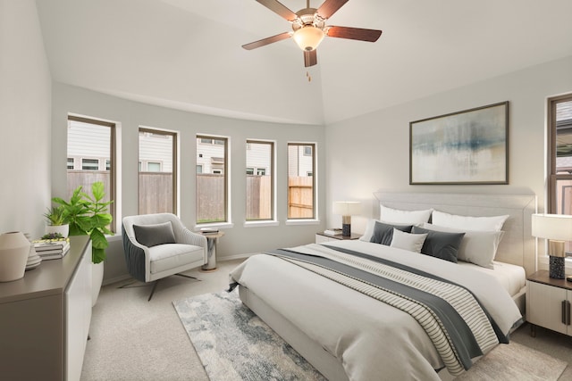 carpeted bedroom with ceiling fan and lofted ceiling