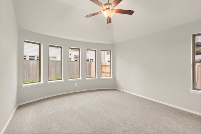 carpeted empty room with lofted ceiling and ceiling fan