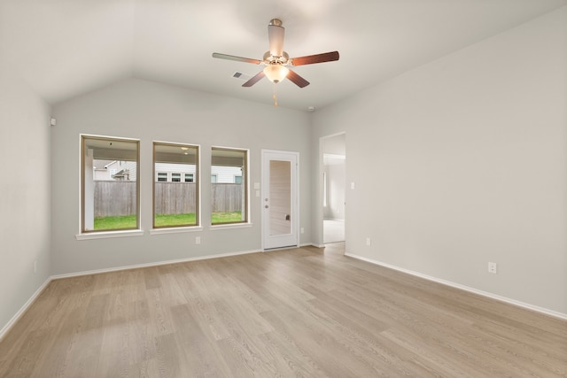 spare room with light hardwood / wood-style flooring, lofted ceiling, and ceiling fan