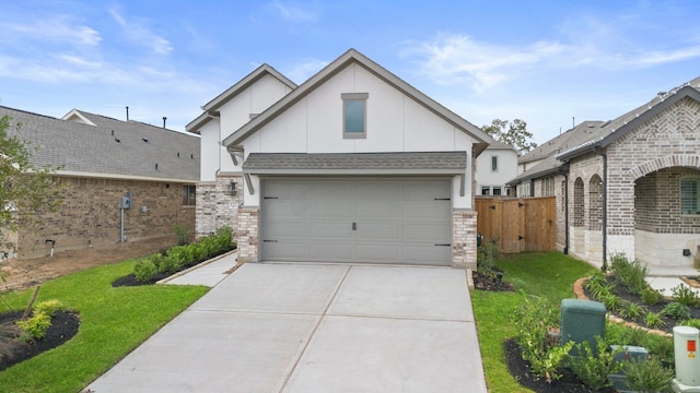 view of front of house featuring a garage and a front lawn