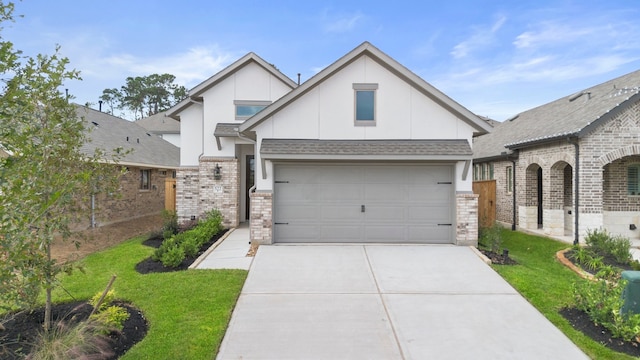 view of front of home featuring a garage and a front lawn