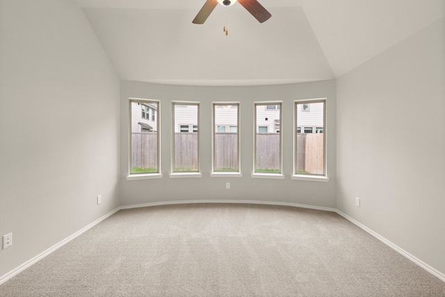 spare room featuring carpet flooring, lofted ceiling, and ceiling fan