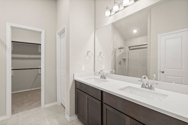 bathroom with vanity, lofted ceiling, tile patterned flooring, and a shower with door