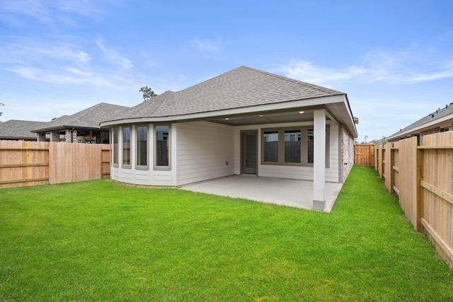 rear view of property featuring a patio area and a lawn