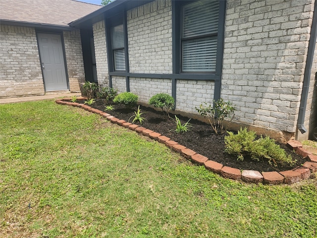 view of side of home featuring a yard