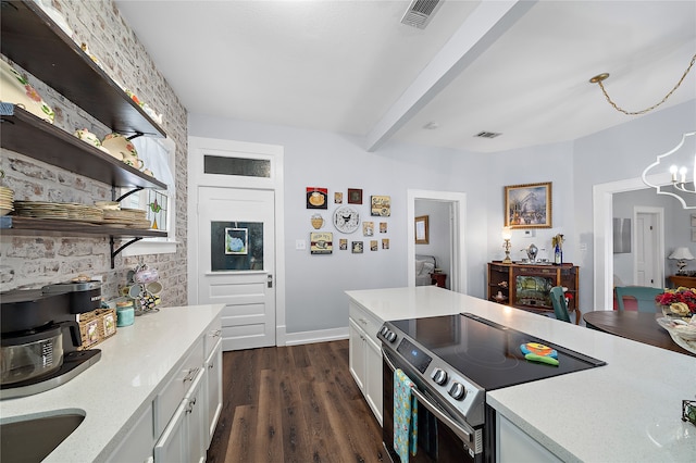 kitchen featuring stainless steel range with electric stovetop, white cabinetry, dark wood-type flooring, and a chandelier