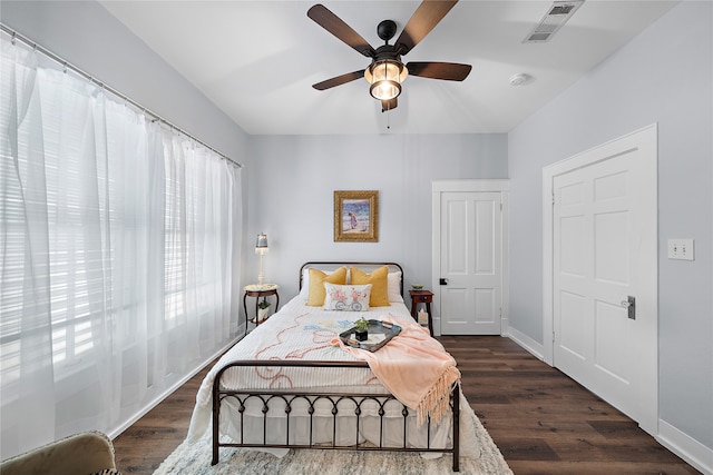 bedroom with ceiling fan and dark hardwood / wood-style flooring