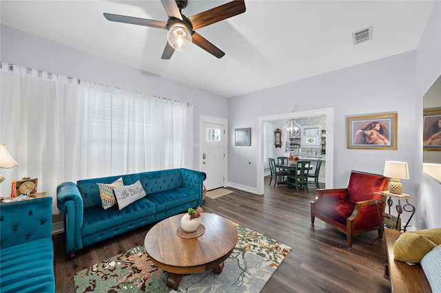 living room with dark wood-type flooring and ceiling fan