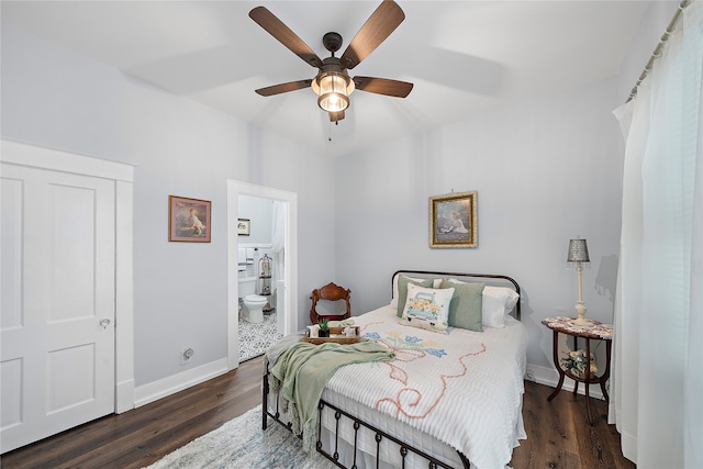 bedroom with ensuite bath, dark wood-type flooring, and ceiling fan