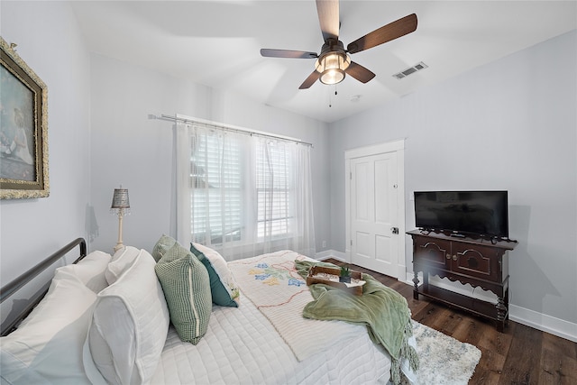 bedroom with ceiling fan and dark hardwood / wood-style floors