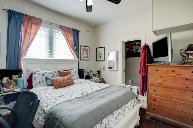 bedroom with ceiling fan, multiple windows, and dark hardwood / wood-style flooring