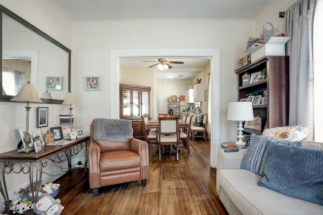 living room with ceiling fan, dark hardwood / wood-style flooring, and ornamental molding