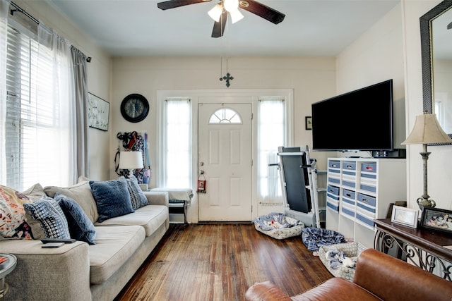 living room with dark hardwood / wood-style flooring and ceiling fan