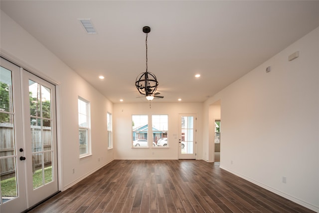 unfurnished dining area featuring a healthy amount of sunlight, french doors, and dark hardwood / wood-style flooring