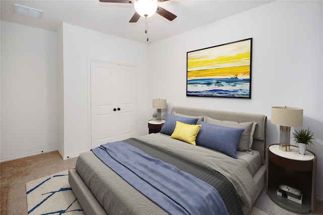 bedroom with carpet, ceiling fan, and a closet