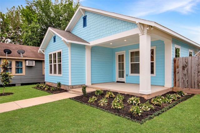 view of front of house with a front yard and covered porch