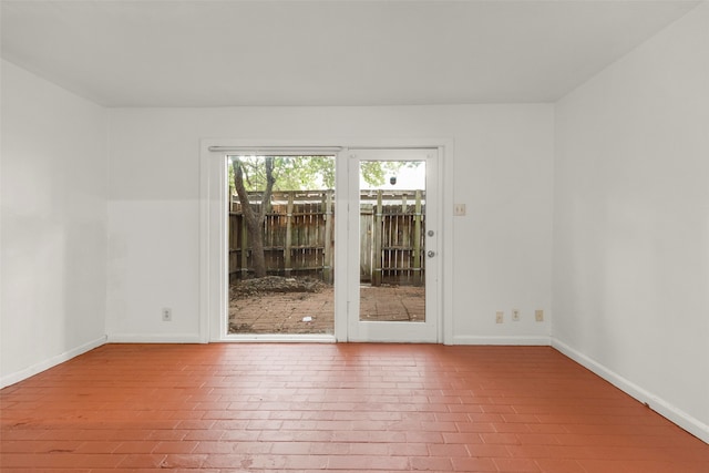 unfurnished room with wood-type flooring