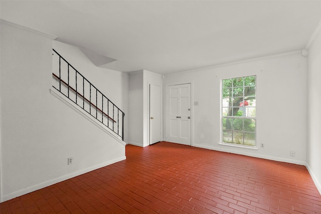 foyer entrance with ornamental molding and plenty of natural light