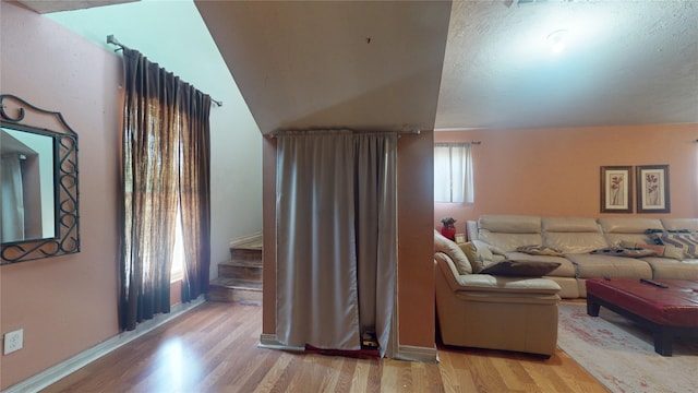 living room with vaulted ceiling and light hardwood / wood-style flooring