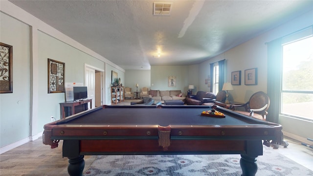 recreation room with a healthy amount of sunlight, light wood-type flooring, and billiards